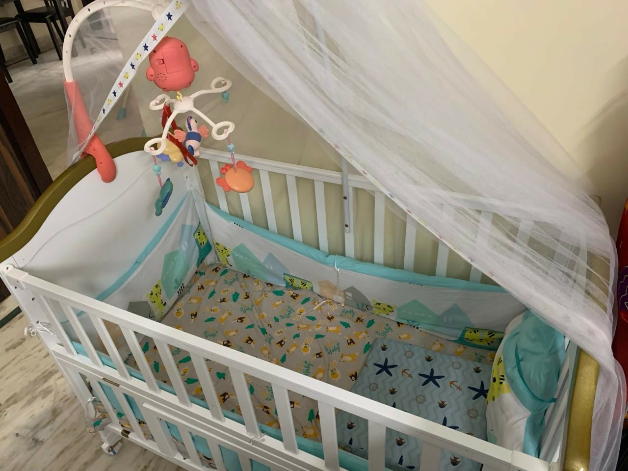 The StarAndDaisy Premium 12-in-1 Baby Bed Cot Crib is the perfect nursery essential, growing with your child while offering versatile features like cradle, bed, and desk functionality, with convenient storage!