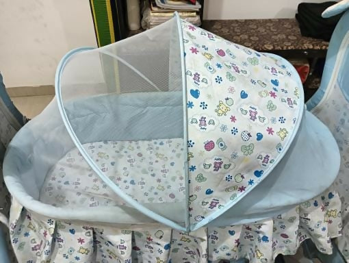 Provide your baby with a cozy, safe, and stylish sleeping space with the Mandot Impex 1st Step Cradle, complete with a swing, mosquito net, and storage basket!