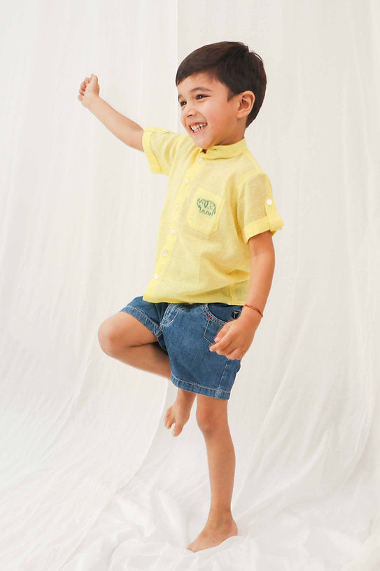 Discover the bright yellow 100% cotton shirt for boys, offering soft, breathable comfort and vibrant style for any occasion.