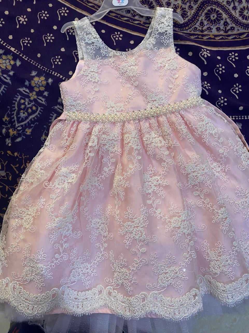 Adorn your baby girl in this elegant Pearl and Lace Work Frock, perfect for making precious memories!






