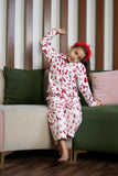  The set includes a long-sleeved top with a collar and matching pants, both adorned with delightful red prints of reindeer, snowflakes, and Christmas trees on a white background. 