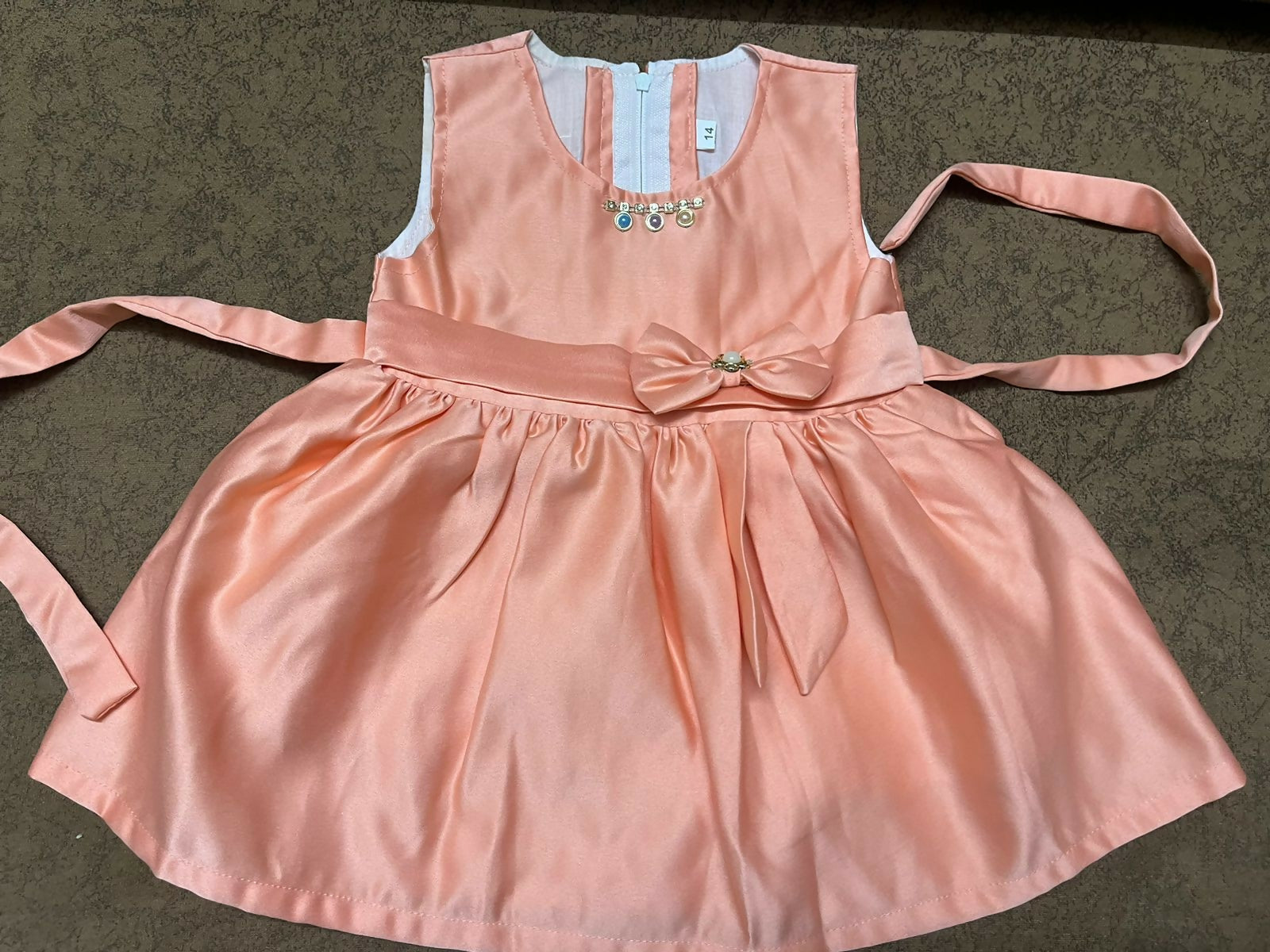 Explore elegant partywear dresses/frocks for baby girls, featuring intricate detailing and comfortable fabric for special occasions.